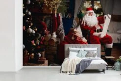 Papier Peint Photo Vinyle - Père Noël Assis Sur Une Chaise Avec Un Sac Plein De Cadeaux, Largeur 600 Cm X Hauteur 400 Cm - Tirage Photo Sur Papier Peint (disponible En 7 Tailles) -Jingle Bells Boutique 1200x800 148