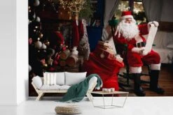 Papier Peint Photo Vinyle - Père Noël Assis Sur Une Chaise Avec Un Sac Plein De Cadeaux, Largeur 600 Cm X Hauteur 400 Cm - Tirage Photo Sur Papier Peint (disponible En 7 Tailles) -Jingle Bells Boutique 1200x800 150